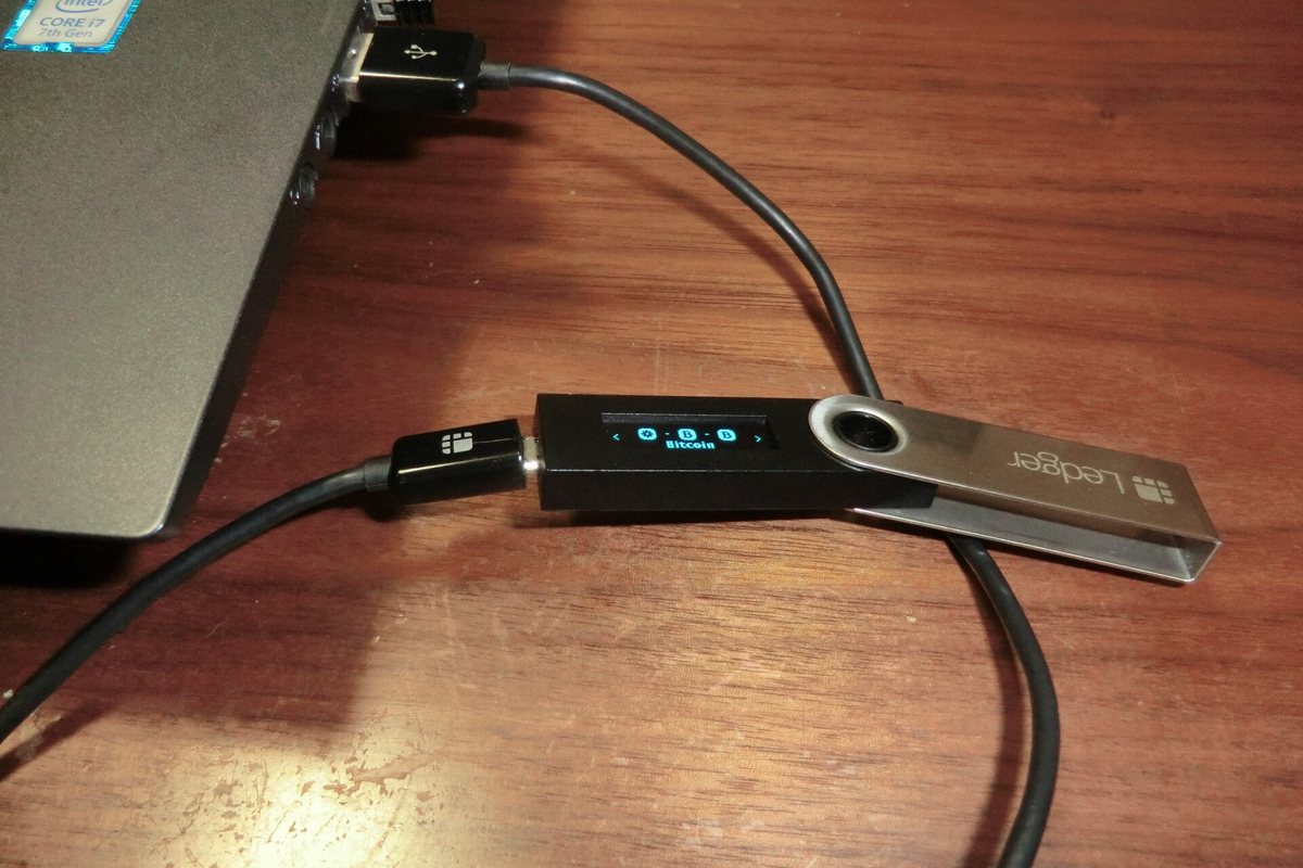 Ledger Nano S hardware wallet connected to a laptop by USB cable